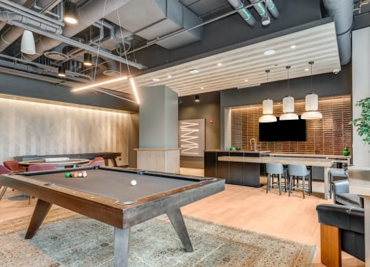a game room with a pool table and a bar  at Cassidy on Canal, Chicago, Illinois
