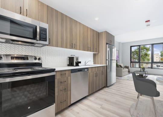 a kitchen with stainless steel appliances and wooden cabinets