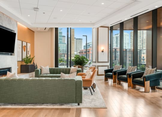 a living room with couches and chairs and a view of the city  at Cassidy on Canal, Chicago, Illinois