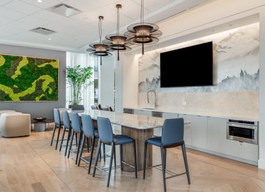 the lobby of a hotel with a bar with blue chairs  at Cassidy on Canal, Chicago, IL
