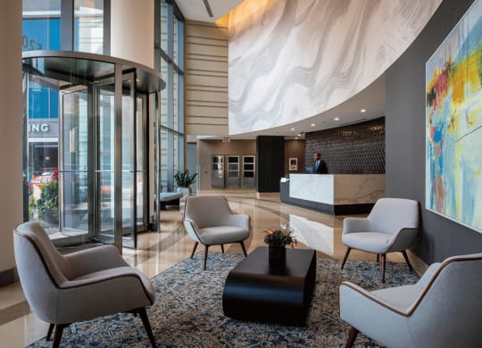 Updated lobby with white chairs and a large painting on the wall Kingsbury Plaza view at Kingsbury Plaza, Chicago, I