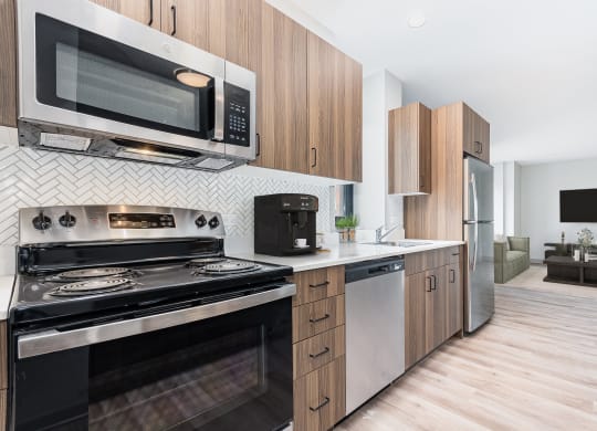 a kitchen with stainless steel appliances and wooden cabinets