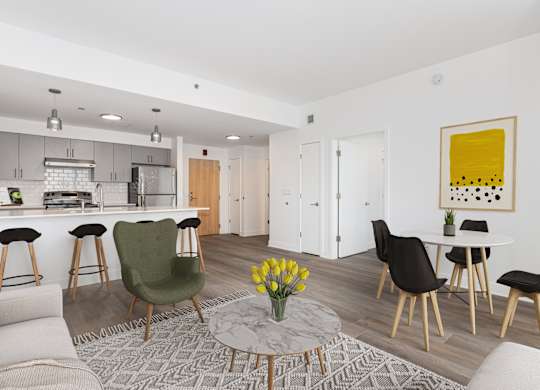A modern living room with a green chair and a yellow painting on the wall.