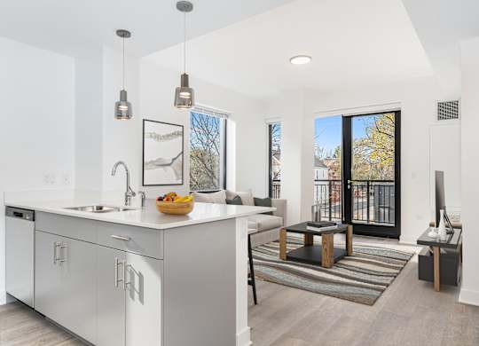 A modern kitchen with white cabinets and a large island.