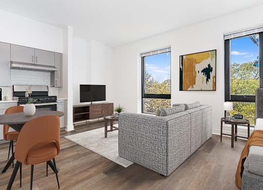 A modern living room with a grey sofa and a television.