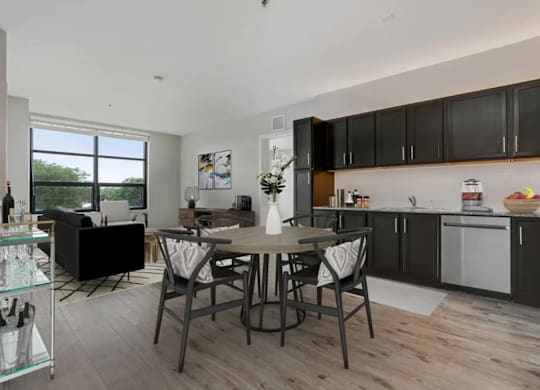 a kitchen and dining room with a table and chairs