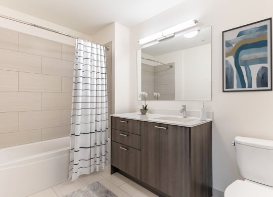 a bathroom with a toilet sink and shower and a mirror at One 333, Chicago, IL, 60605