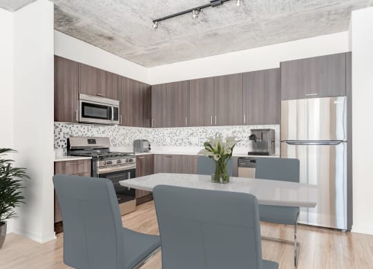 a kitchen and dining room with a table and chairs at One 333, Chicago, IL