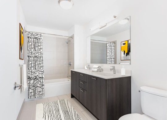 a white bathroom with a black and white shower at One 333, Chicago, IL, 60605
