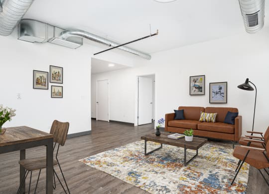 a living room with a couch and a table    and a dining table