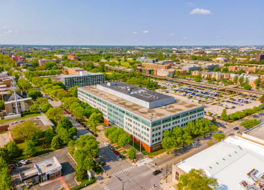 an aerial view of a large building with a parking lot in front of it