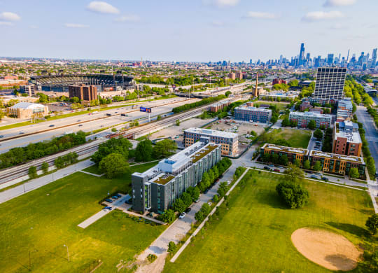 an aerial view of the campus with the chicago skyline in the background
