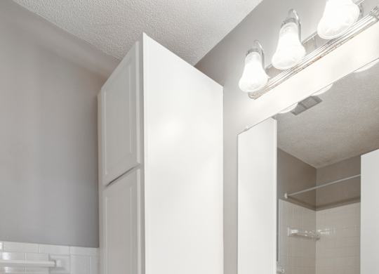 Bathroom vanity with white cabinets and storage at Cedarvale Highlands Apartments, Minnesota