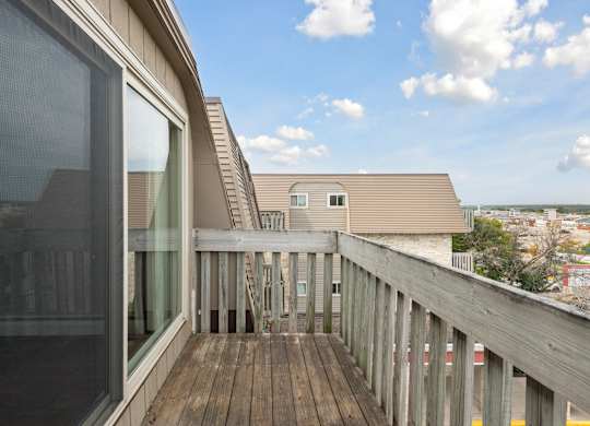 Private balcony with wooden deck and railings at Cedarvale Highlands Apartments, Minnesota, 55122