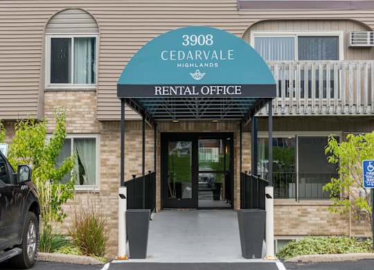 Rental office entrance with covered awning at Cedarvale Highlands Apartments, Eagan, Minnesota