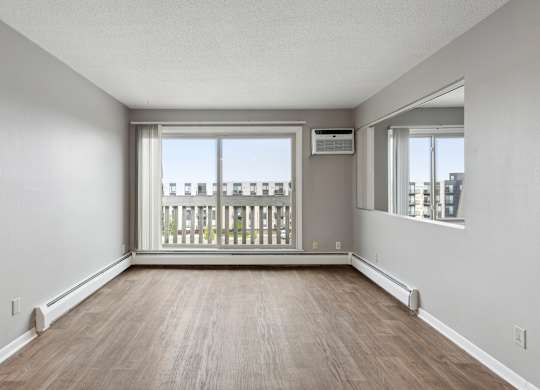 Empty living room with large windows at Cedarvale Highlands Apartments, Eagan, Minnesota