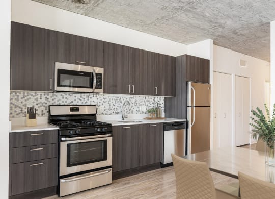 a kitchen with stainless steel appliances and wooden cabinets at One 333, Chicago, Illinois, 60605
