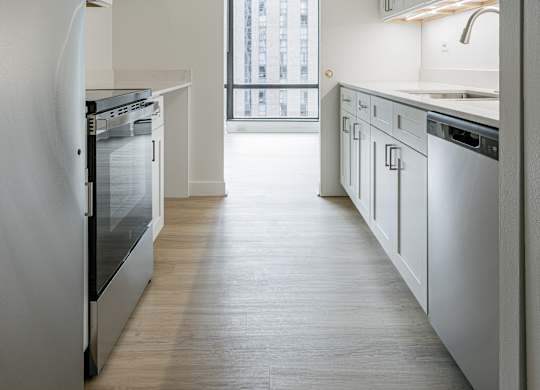 A kitchen with white appliances and cabinets at Columbus Plaza, Illinois, 60601