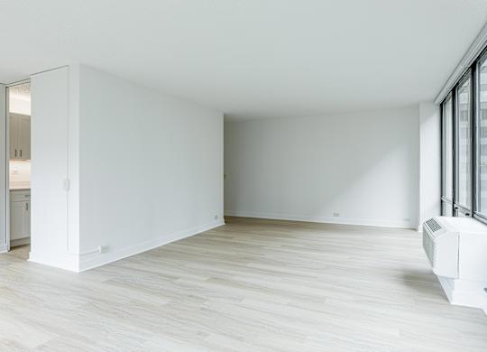 A white room with a sliding door and a window at Columbus Plaza, Chicago, 60601