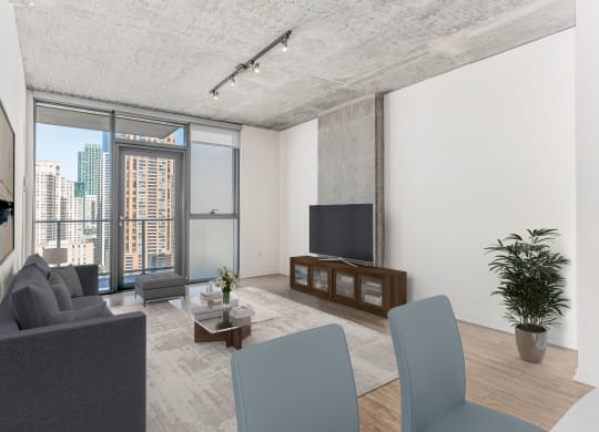 a living room with a gray couch and a tv at One 333, Chicago, Illinois
