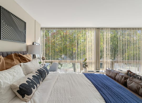 a bedroom with a large bed and a large window at the Pavilion at The Pavilion, Detroit, Michigan