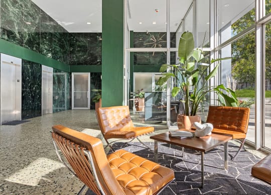 a lobby with leather chairs and a coffee table at The Pavilion, Detroit, Michigan