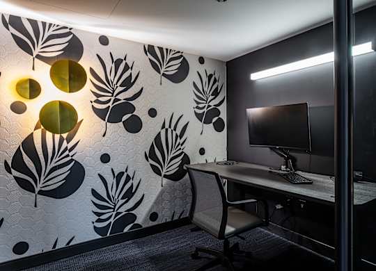 A modern office with a leaf patterned wallpaper and a desk with a computer at Kingsbury Plaza, Chicago, IL, 60654