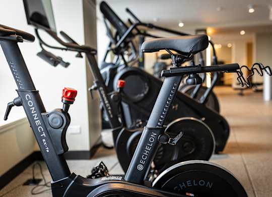 A row of stationary bikes are lined up in a gym at Kingsbury Plaza, Chicago, IL, 60654