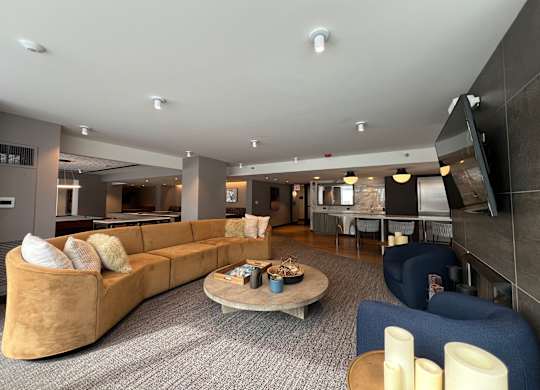 A modern living room with a large sofa and a coffee table at Kingsbury Plaza, Chicago, Illinois
