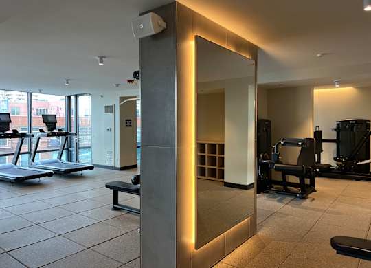 A gym with treadmills, weights and a mirror at Kingsbury Plaza, Chicago, Illinois