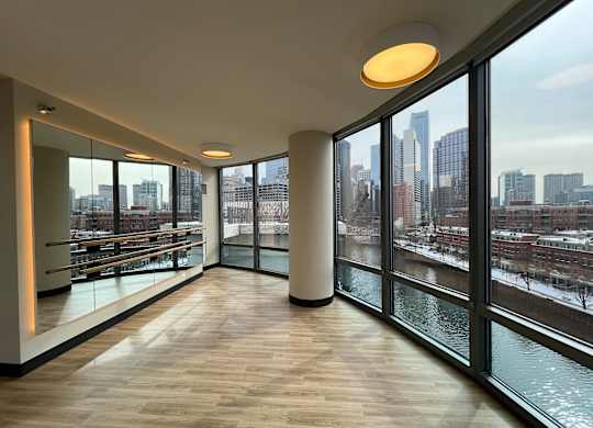 A long hallway with a view of the city outside the windows at Kingsbury Plaza, Chicago, 60654