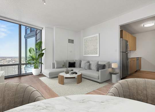 A modern living room with a large window overlooking the city.