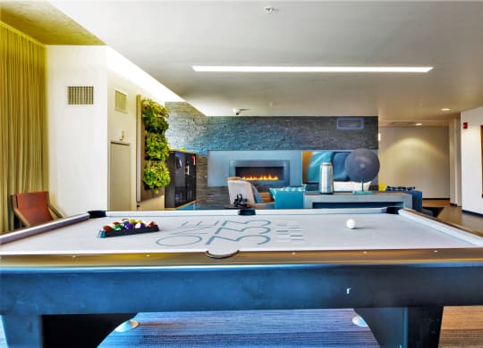 a pool table with a fireplace in the background