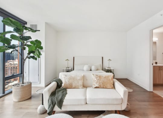 a bedroom with a couch and a bed and a large window at Cassidy on Canal, Chicago, IL, 60654