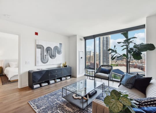 a living room with a large window and a couch and a table at Cassidy on Canal, Chicago, IL, 60654
