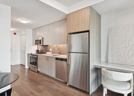 a kitchen with stainless steel appliances and a counter top with a refrigerator at Cassidy on Canal, Chicago, Illinois