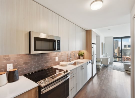 a kitchen with white cabinets and a sink and a microwave at Cassidy on Canal, Chicago, IL, 60654