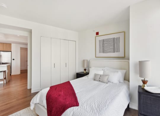 a bedroom with a white bed and a red blanket at Cassidy on Canal, Chicago