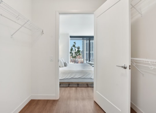 a bedroom with a bed and a door to a closet at Cassidy on Canal, Chicago, IL, 60654