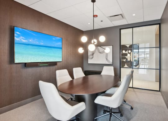 a conference room with a table and chairs and a television at Cassidy on Canal, Chicago, IL, 60654