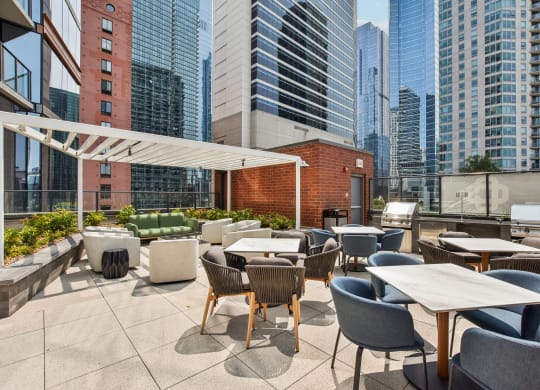 a rooftop patio with tables and chairs and skyscrapers in the background at Cassidy on Canal, Chicago