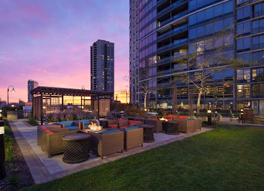 Outdoor fire pits, seating area, and gazebo at sunset at Kingsbury Plaza, Chicago, 60654