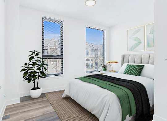 an apartment bedroom with a bed and two windows