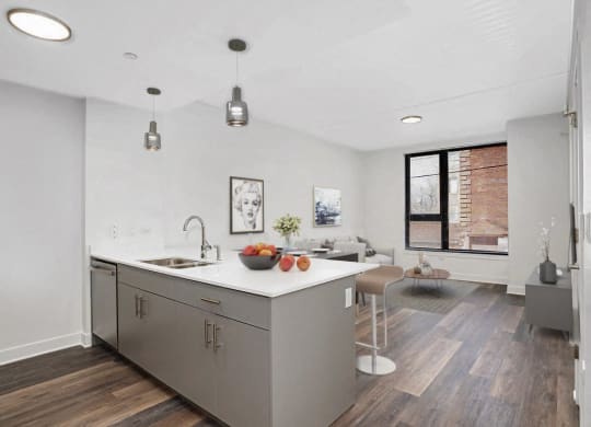 a kitchen with a large island and a living room