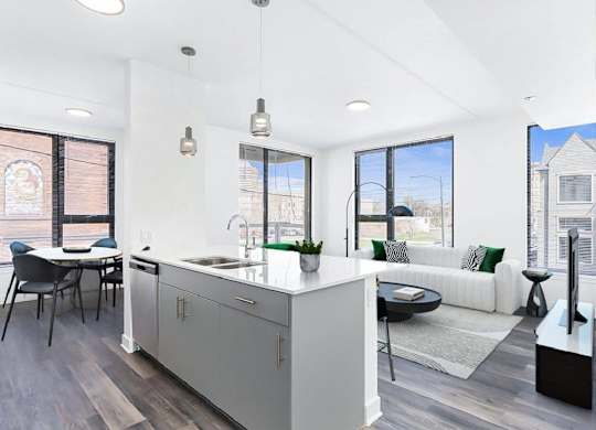 an open living room with a kitchen and a table