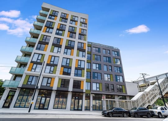 a tall building with cars parked in front of it