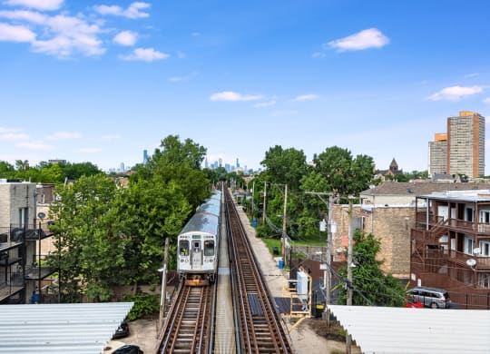 a train traveling down the tracks in a city