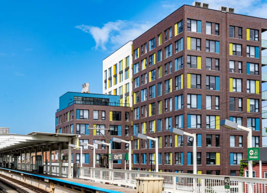a train station in front of a tall building
