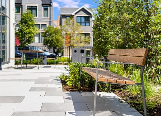 a bench in a garden in front of a building