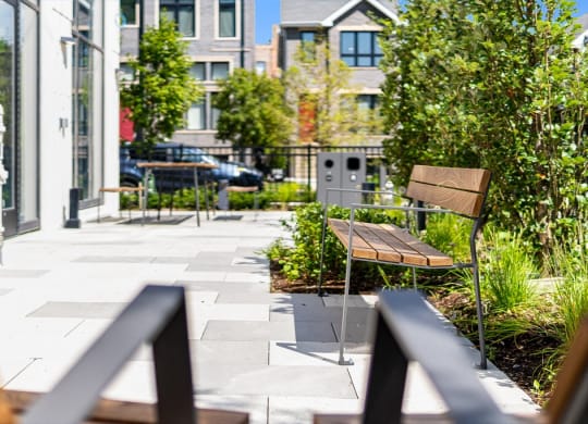 a seating area with a bench and a table on a patio